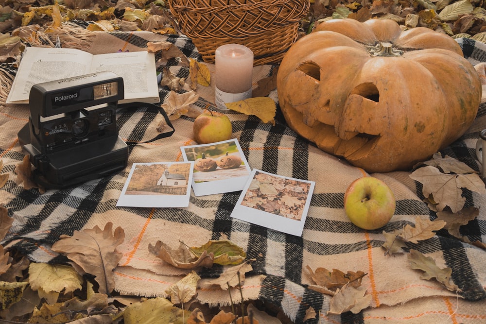 a table topped with pictures and a pumpkin