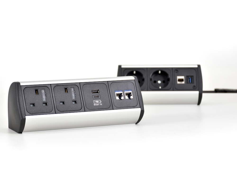 a couple of black and white power strips sitting next to each other