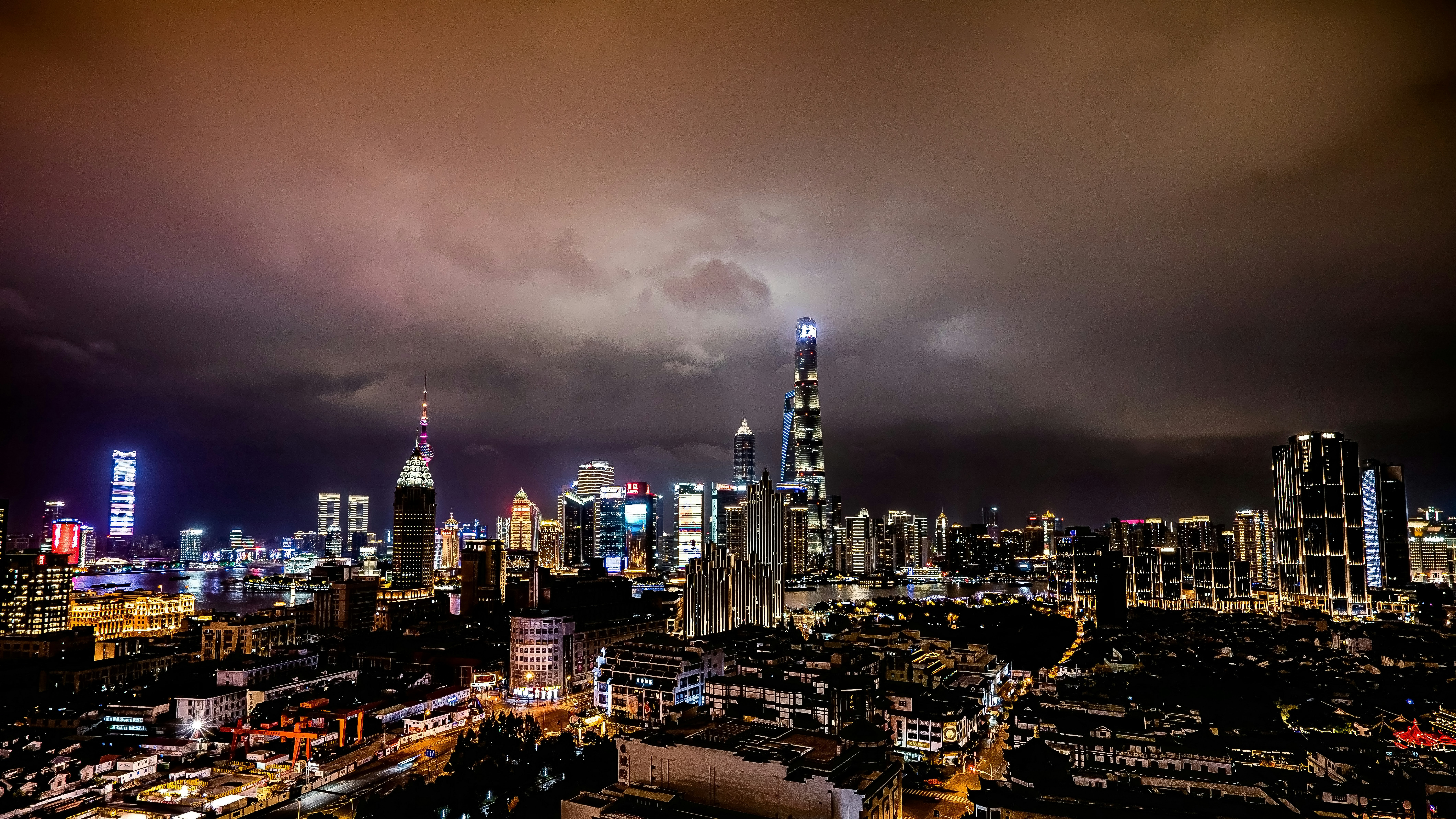 a view of a city at night from the top of a building