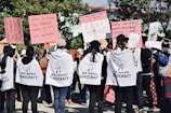 a group of people holding up signs in the street