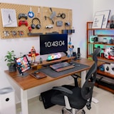 a desk with a computer and a laptop on it
