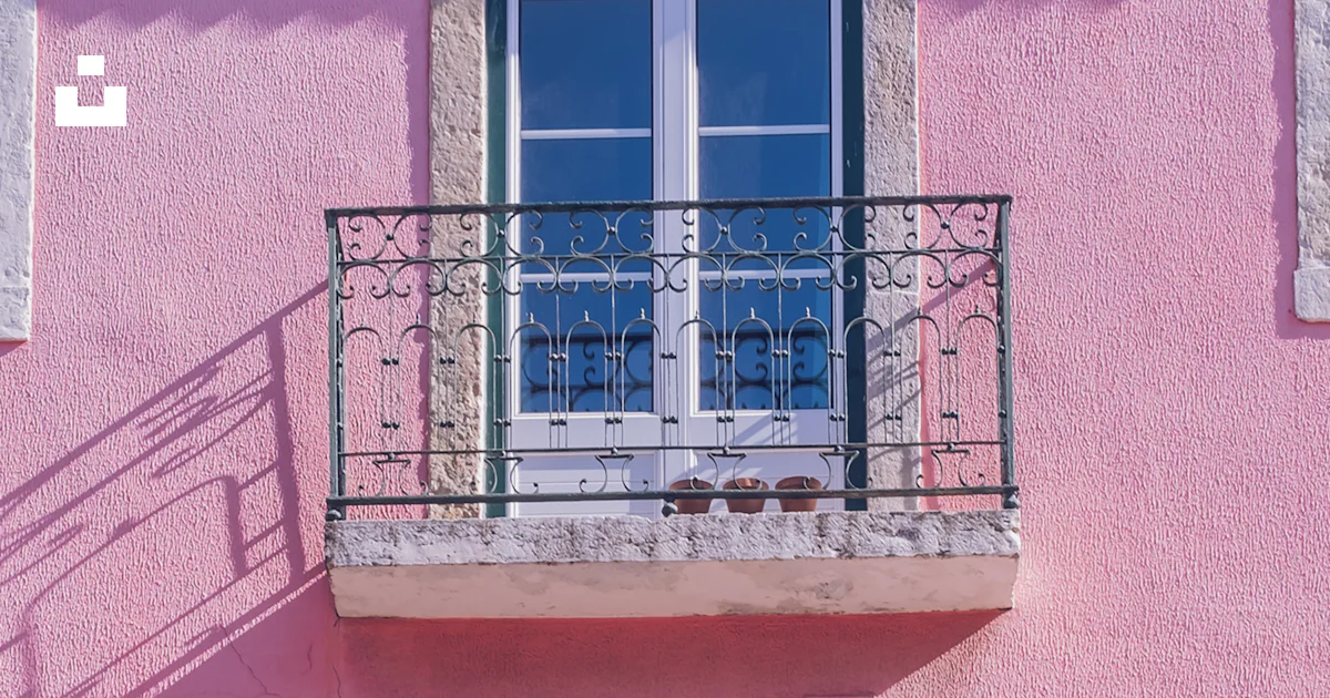 A pink building with two balconies and a balcony photo – Free Window ...