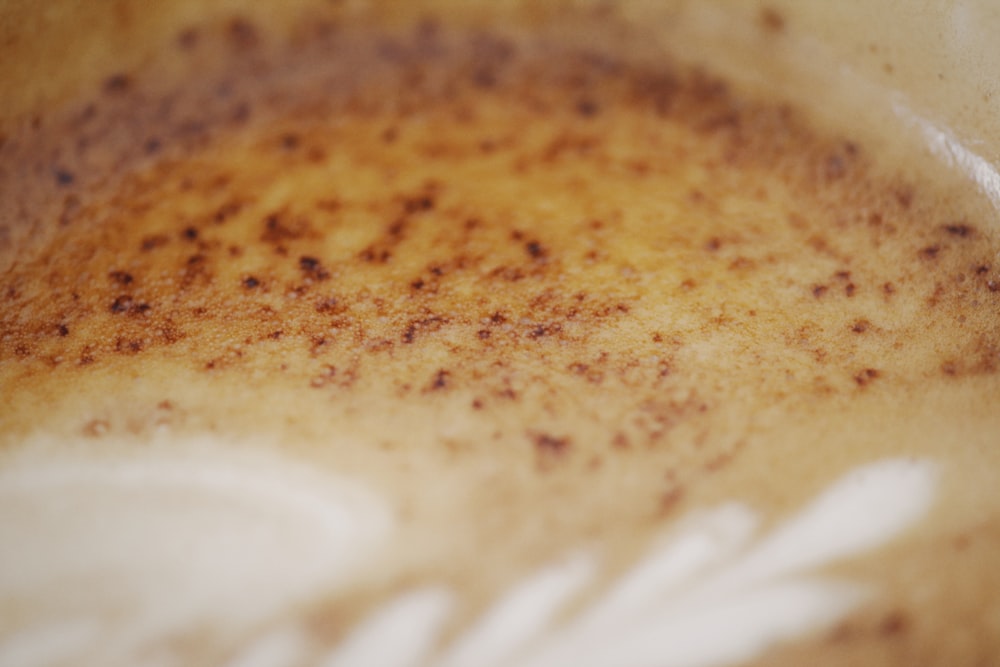 a close up of a brown substance in a white bowl