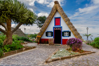 A customizable wendy house with bright colors and a welcoming porch, ideal for home or farm.