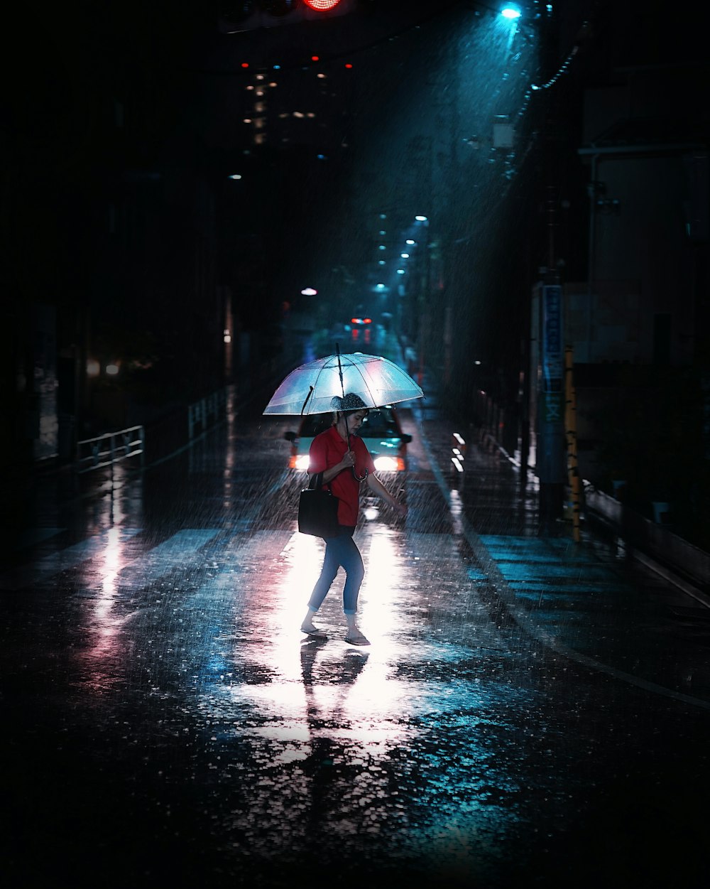 a woman walking down a street holding an umbrella