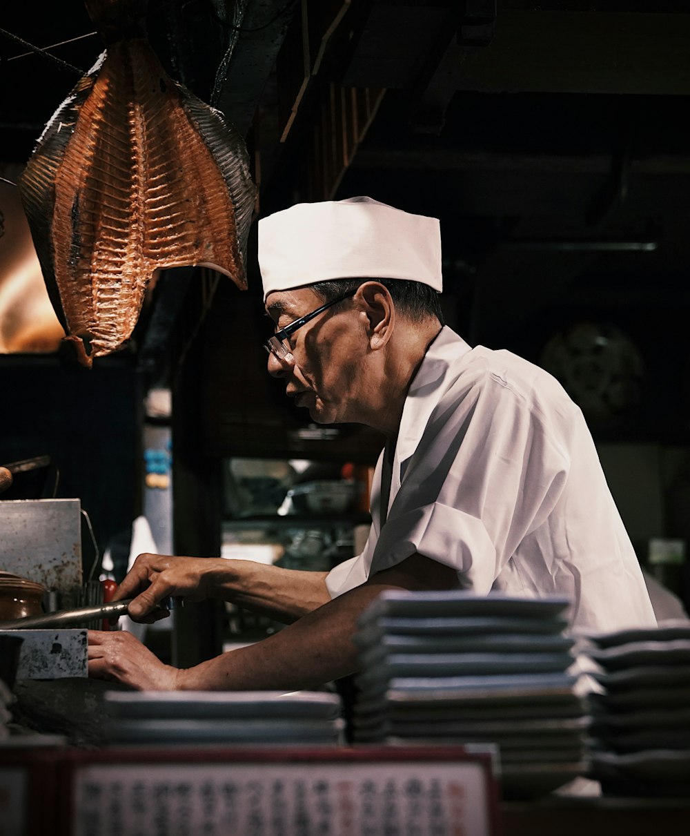 a man in a chef's hat working in a kitchen