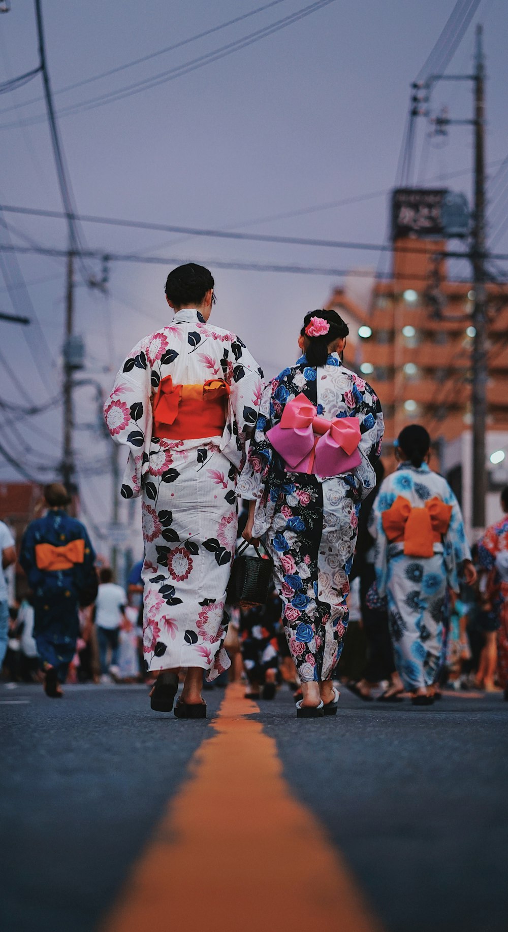 a couple of people that are walking down a street