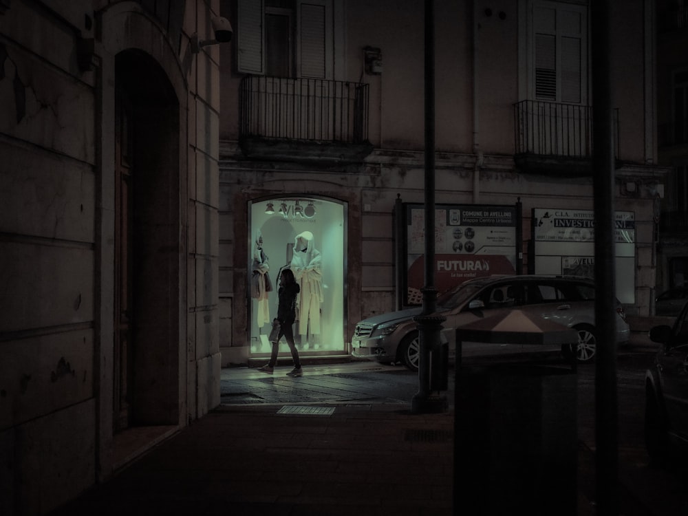 a man standing in a doorway of a building at night