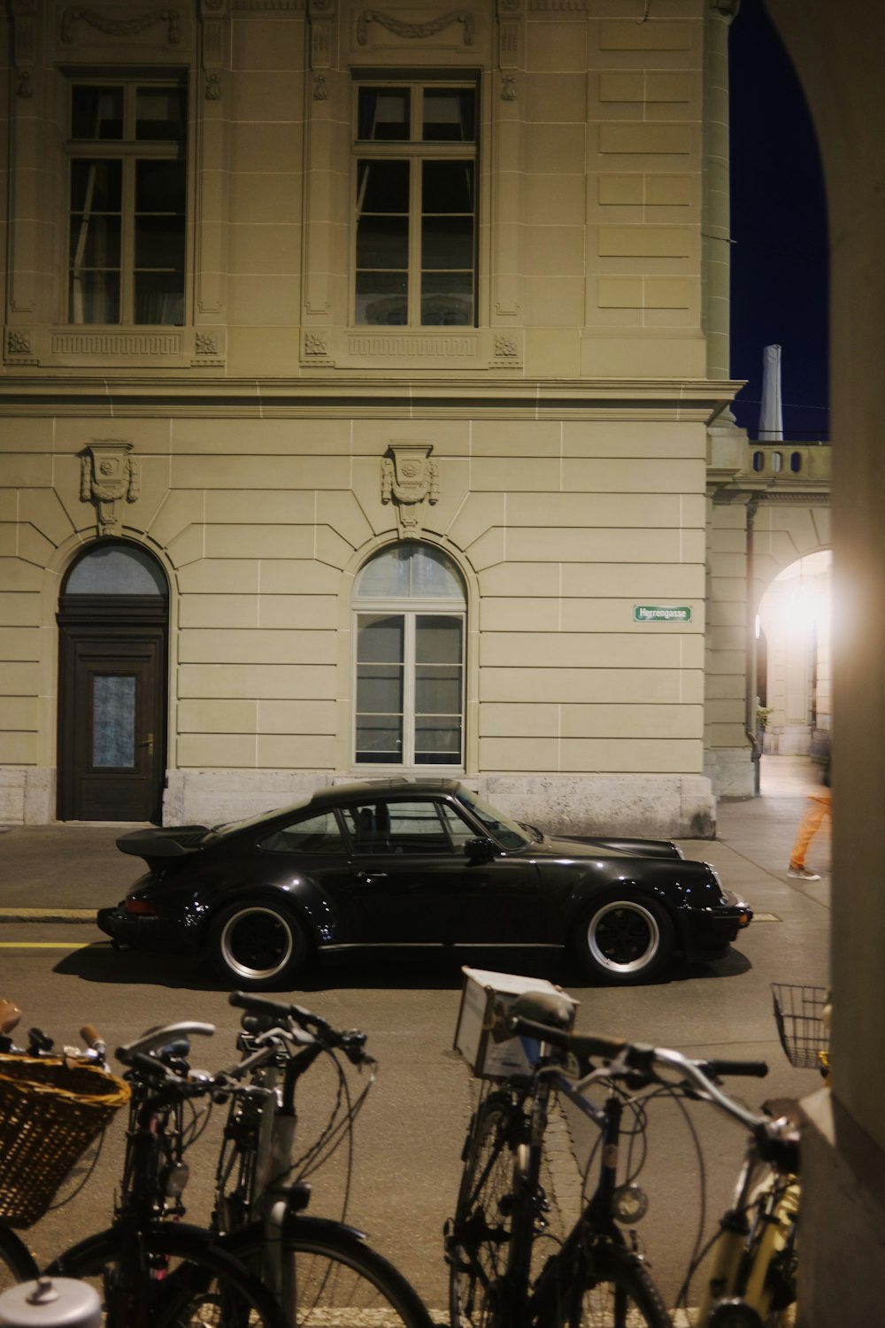 a black car parked in front of a building