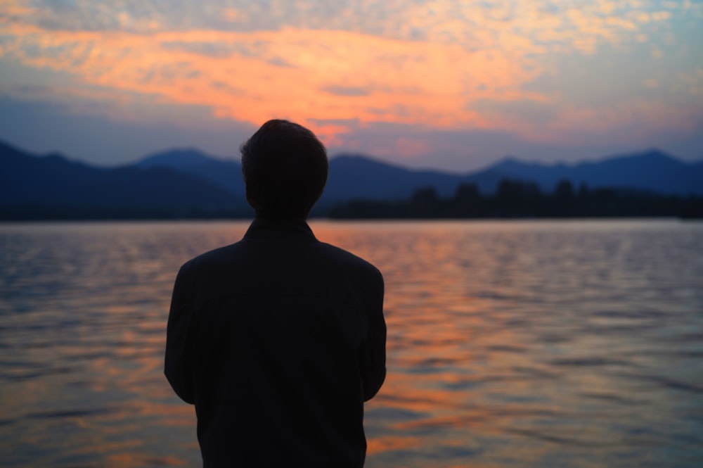 a person standing in front of a body of water