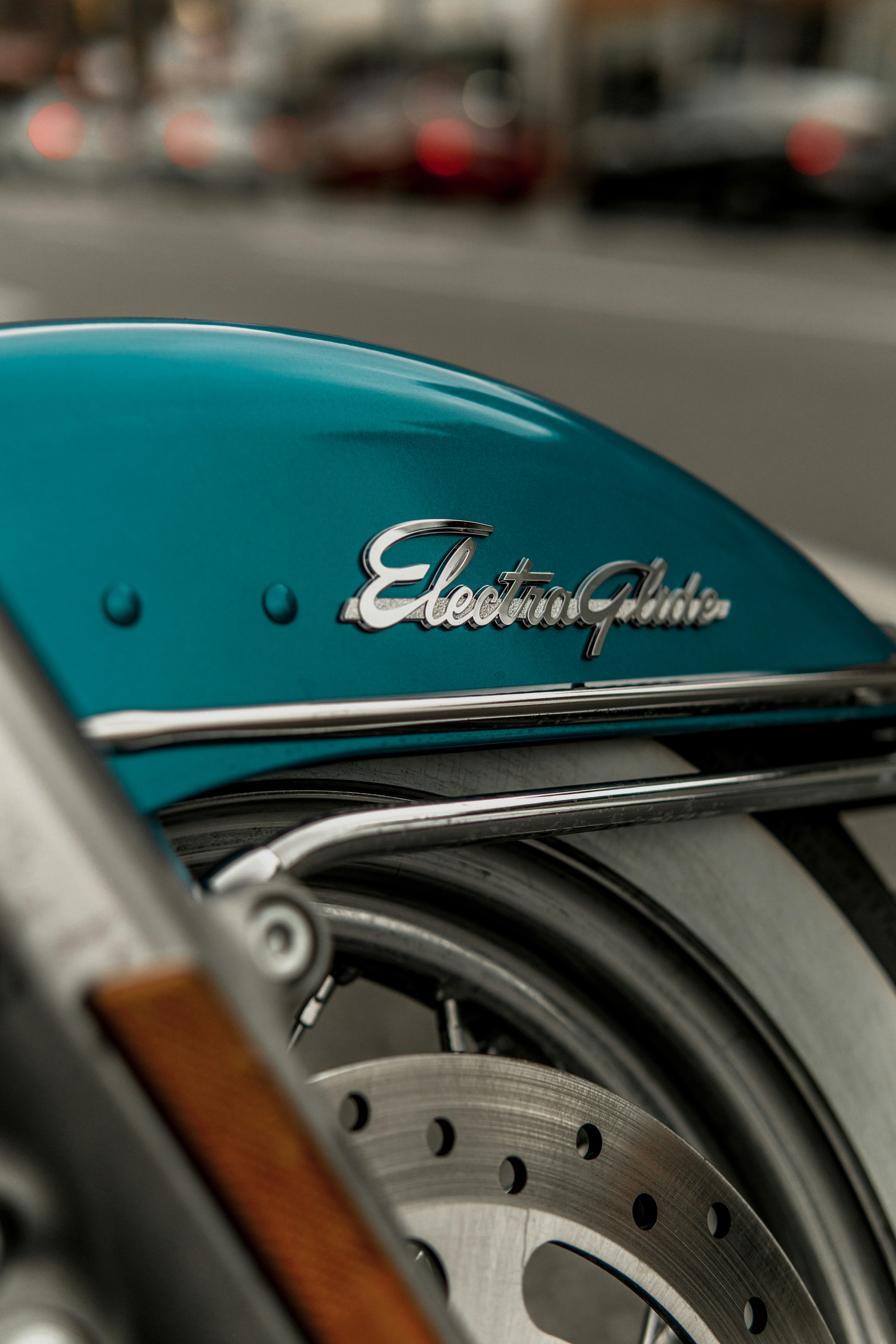 a close up of a blue motorcycle parked on the street