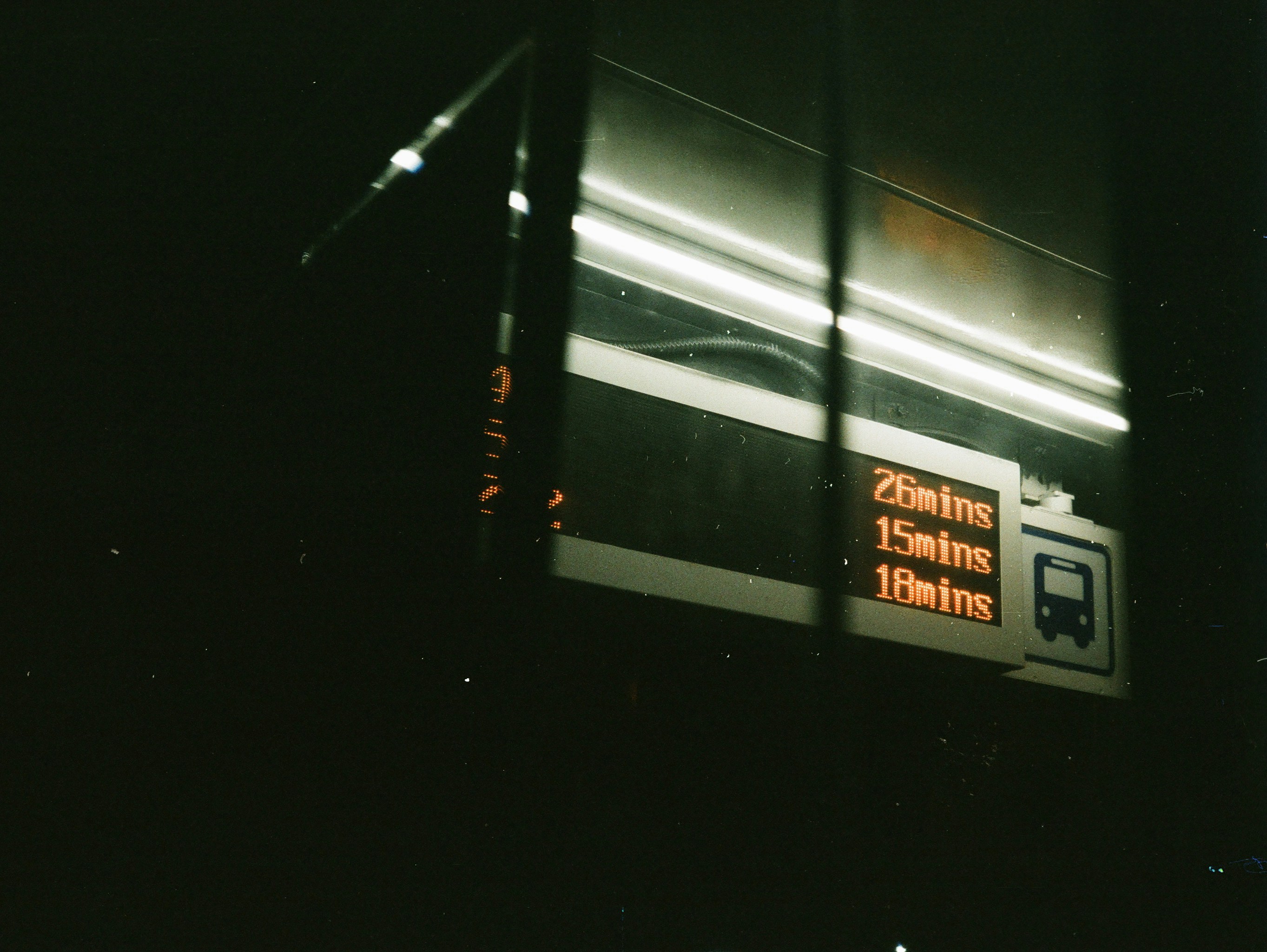 a bus stop with a sign on the side of it