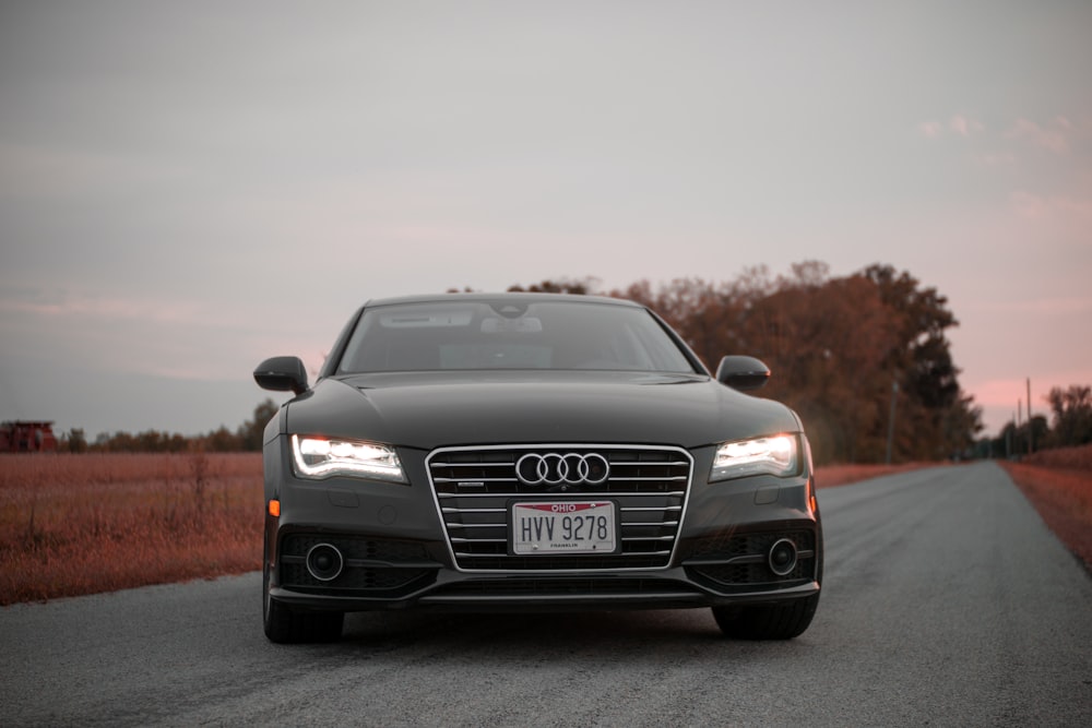 a black car parked on the side of a road