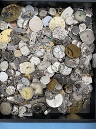 An assortment of antique watch parts laid out neatly on a workbench ready for restoration.