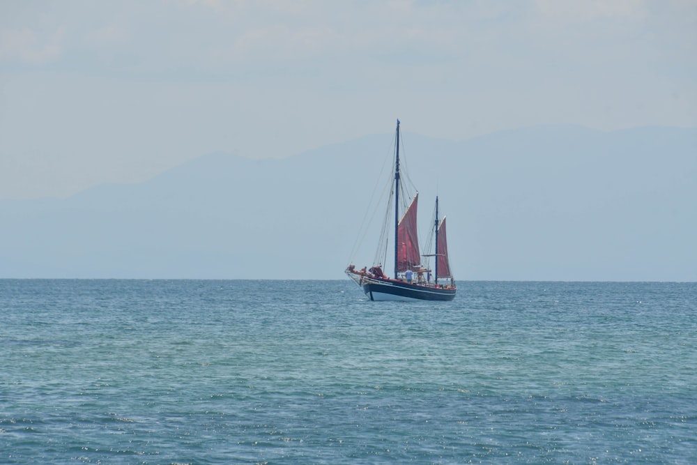 a sailboat in the middle of the ocean