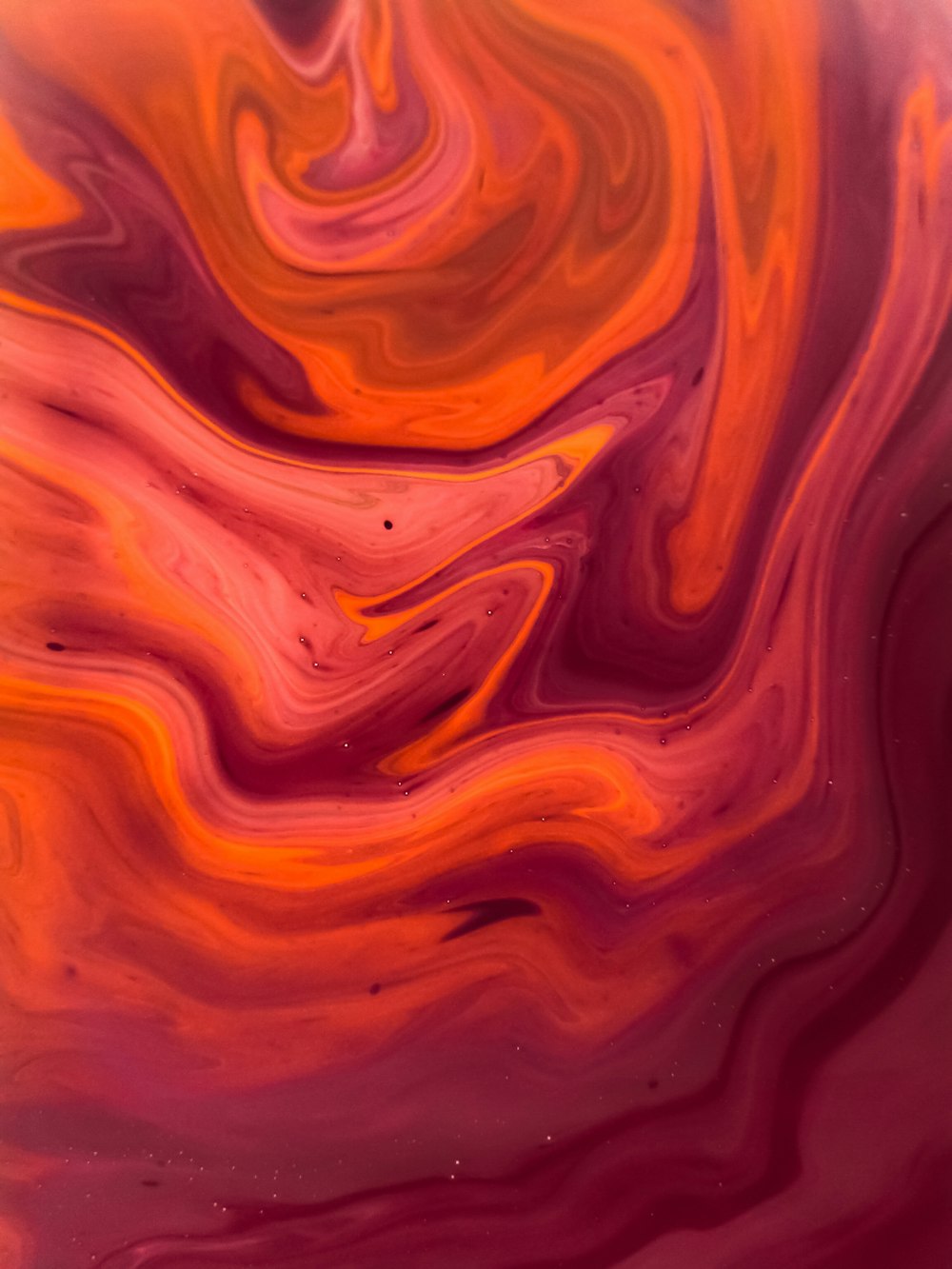 a red and orange swirl with a black background