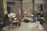 A group of diverse people gathered for a musical rehearsal in a bright studio.