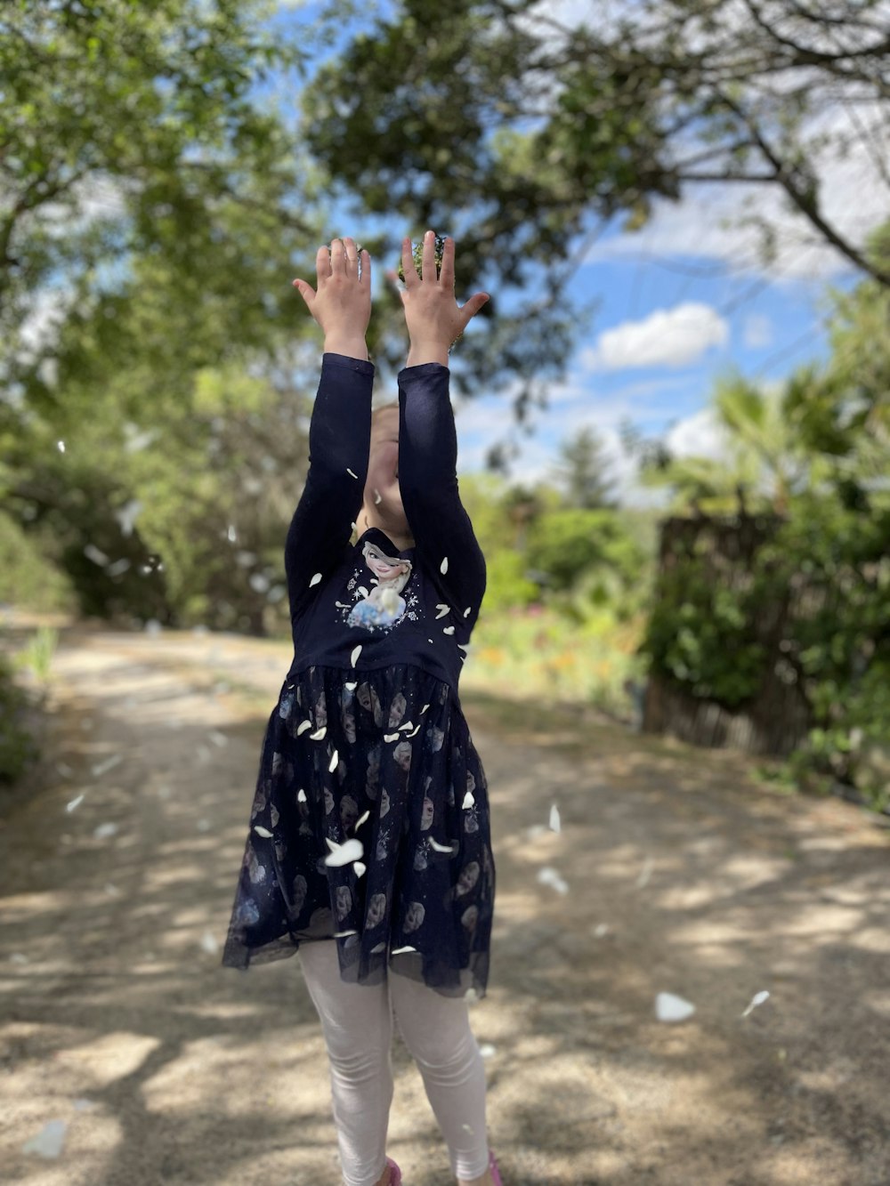 a little girl that is standing in the dirt