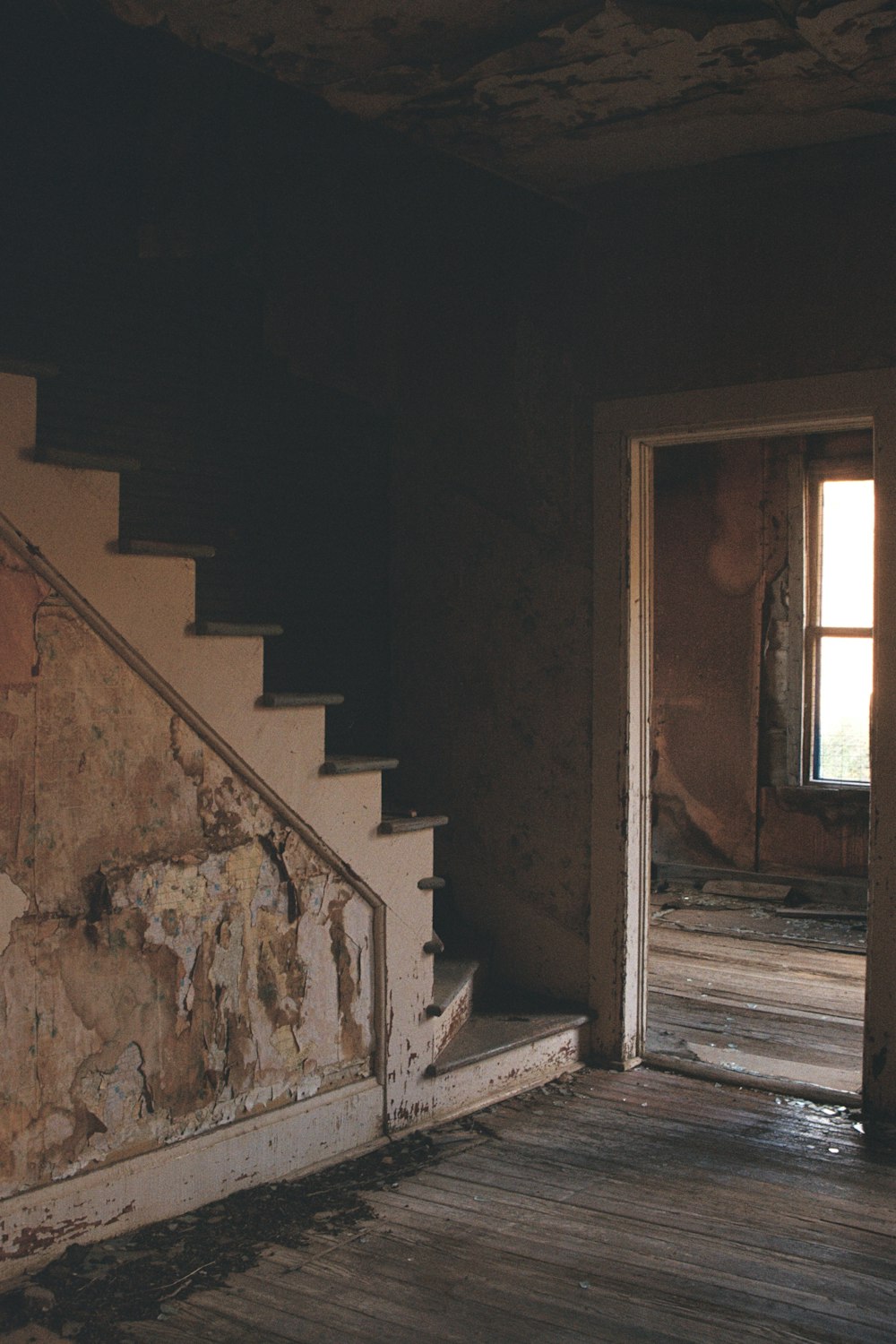 an old run down house with peeling paint on the walls