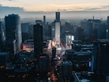 A vibrant cityscape at dusk highlighting digital billboards and technology.
