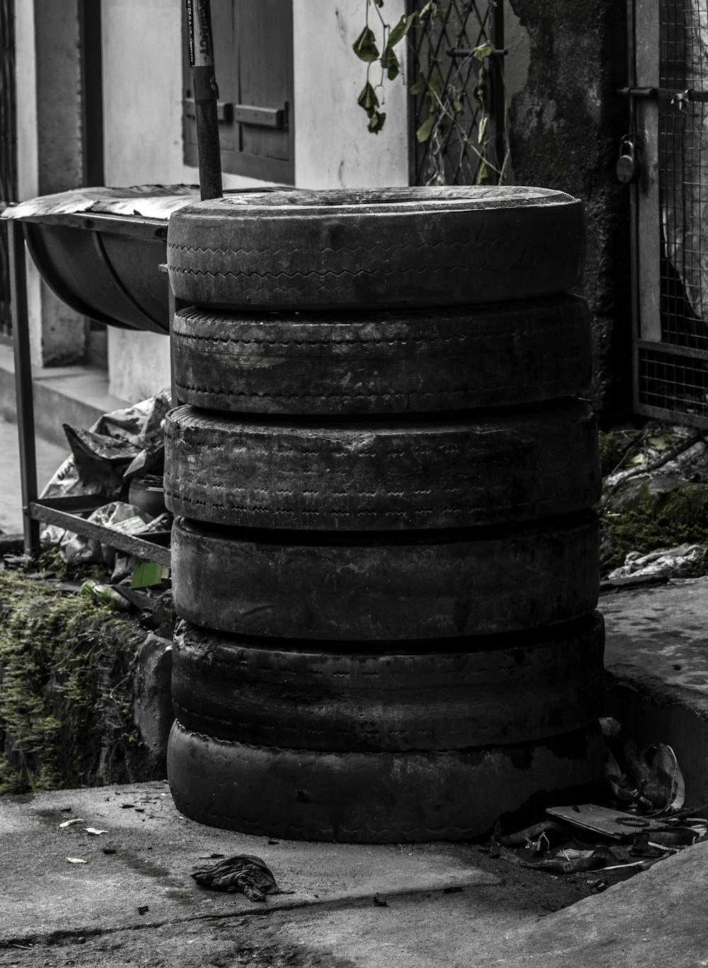 a stack of tires sitting in front of a building