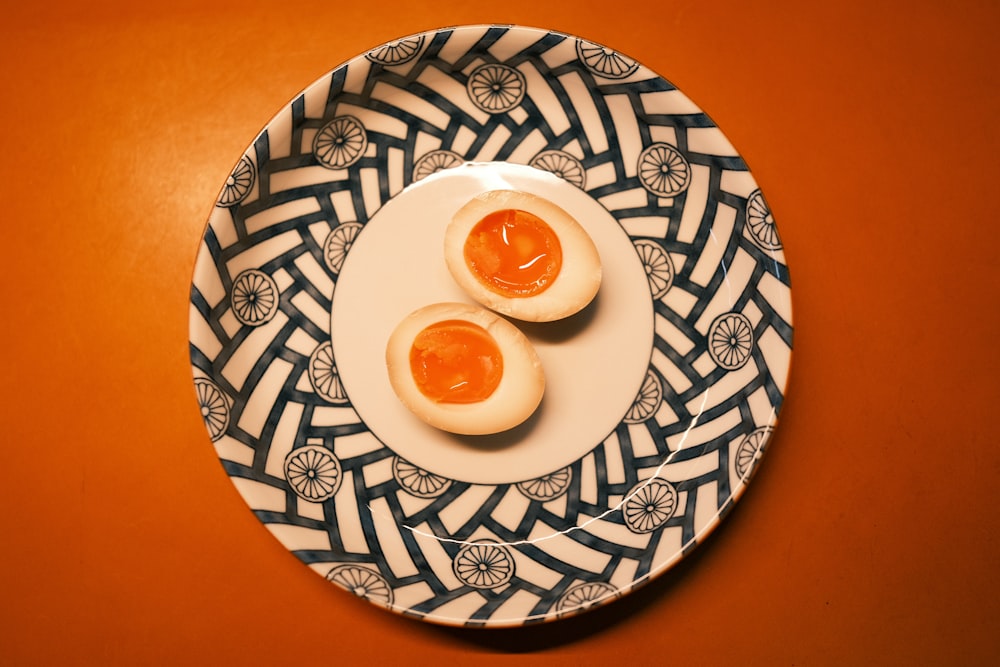 two boiled eggs on a plate on a table