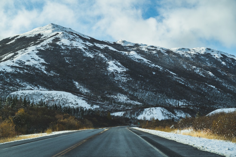 a snow covered mountain with a road going through it