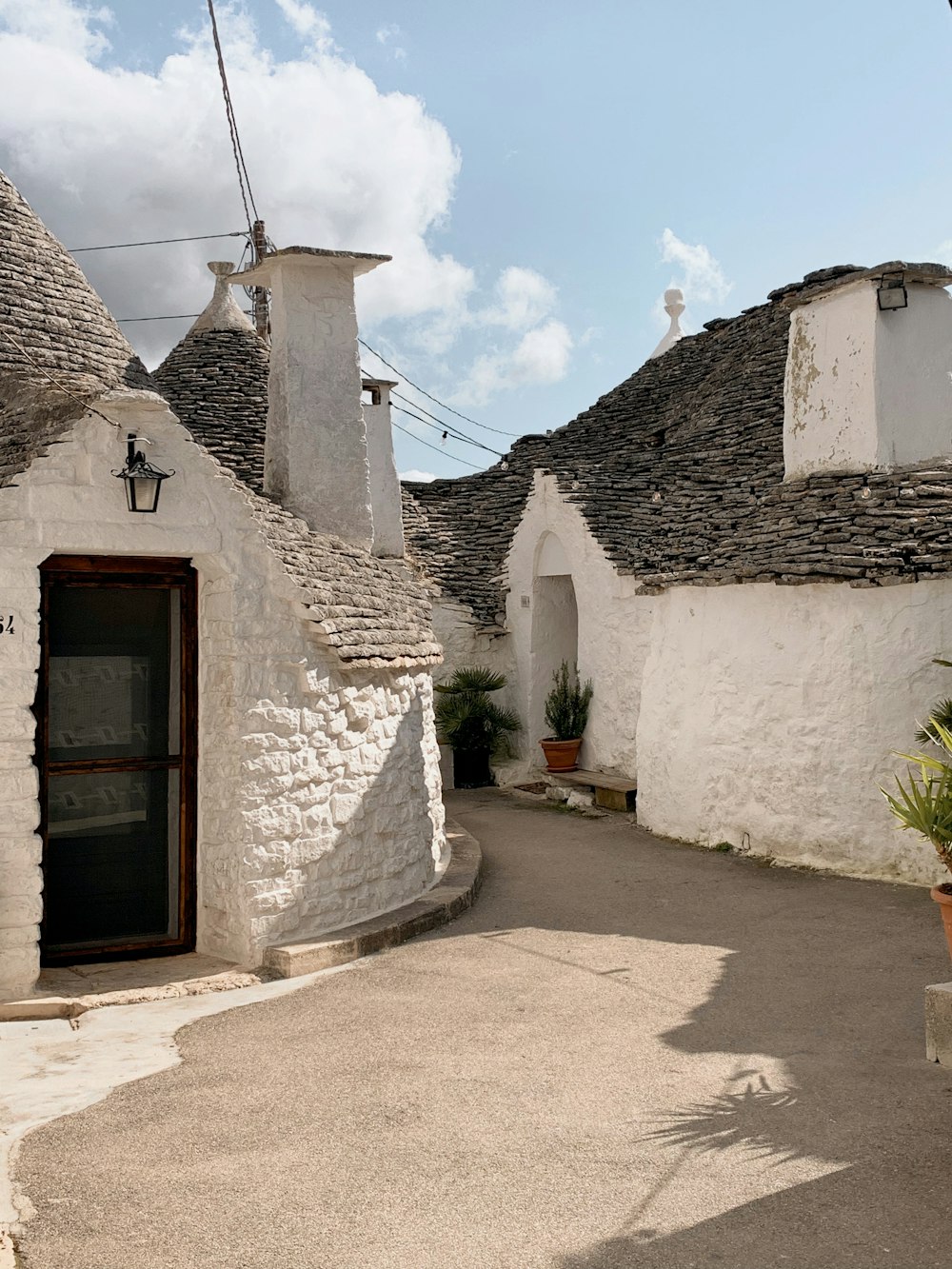 a street lined with white stone buildings under a blue sky