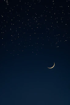 A serene night sky filled with shimmering stars and a glowing crescent moon, reflecting the celestial theme of the blog.