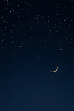 A serene night sky with delicate golden constellations and a crescent moon shining softly.