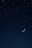 A serene image of a moonlit night sky with stars.