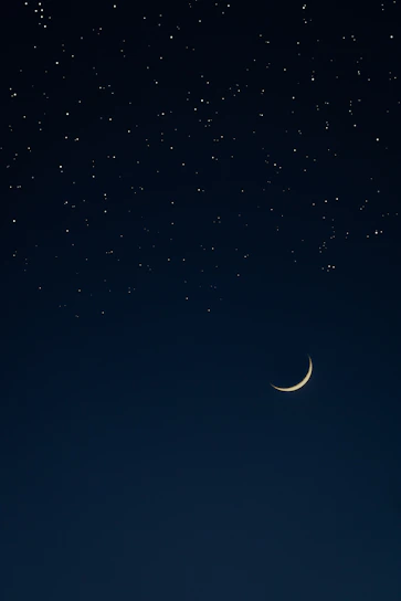 A serene night sky with delicate golden constellations and a crescent moon shining softly.