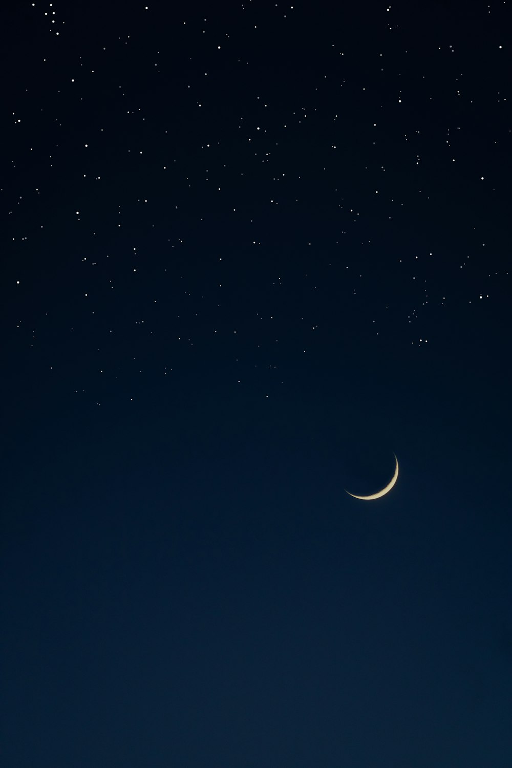 the moon and the stars in the night sky