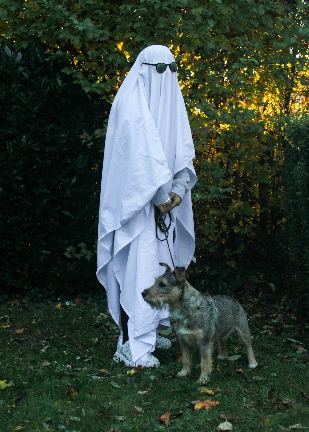 a person in a white outfit and a dog on a leash