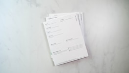 a stack of papers sitting on top of a white counter