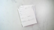 a stack of papers sitting on top of a white counter promoting free nutrition and wellness handouts