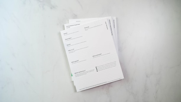 a stack of papers sitting on top of a white counter