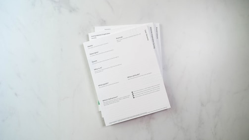 a stack of papers sitting on top of a white counter