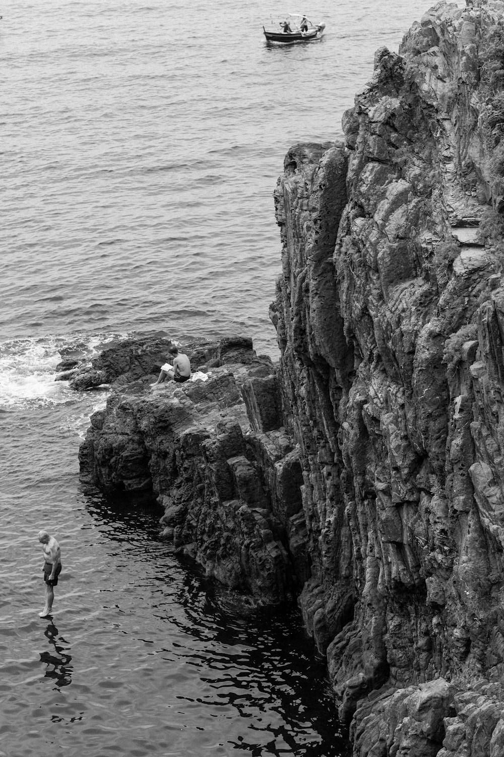 a black and white photo of a person standing in the water