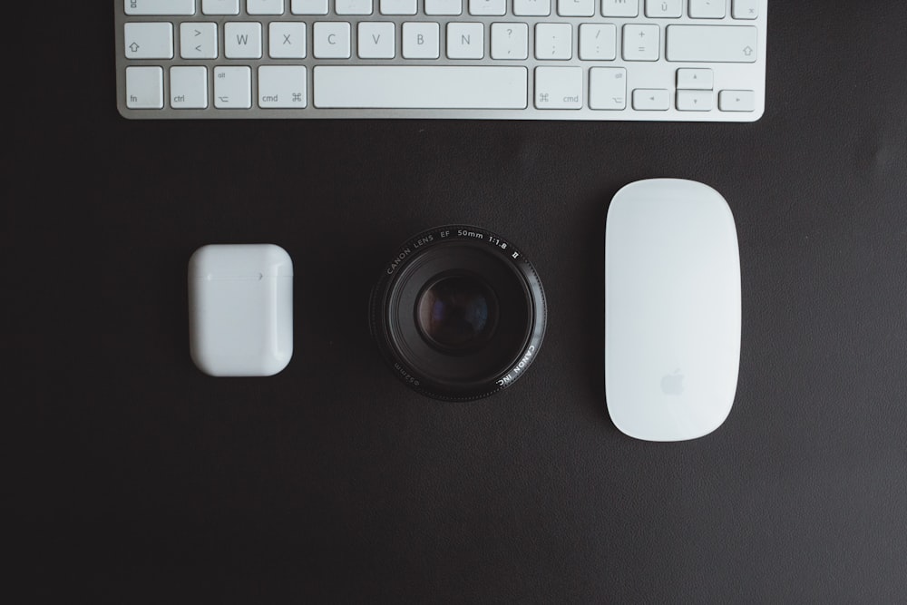 a camera, mouse, and keyboard on a desk