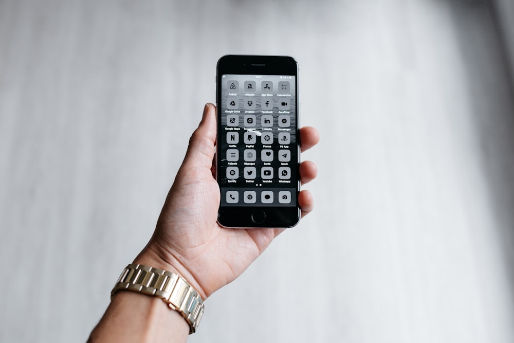 a person holding a cell phone in their hand