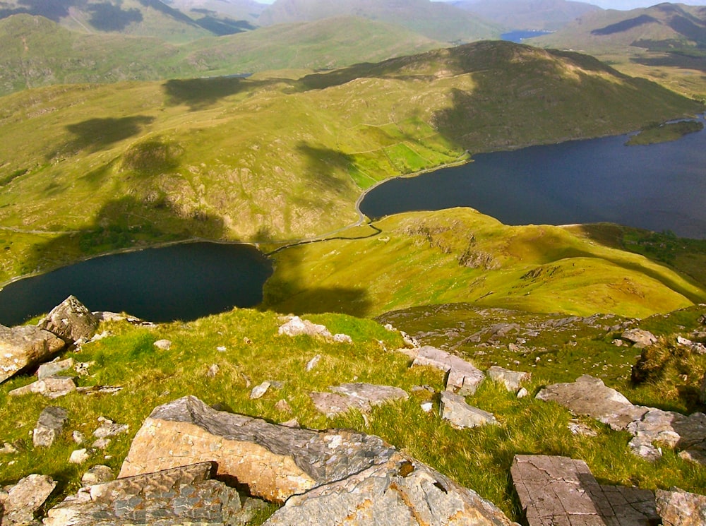 a view of the mountains and lakes from the top of a hill