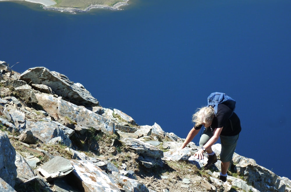 a person with a backpack climbing up a mountain