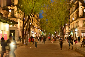 A lively street view of Vibo Place showing storefronts and people enjoying the mixed-use development.