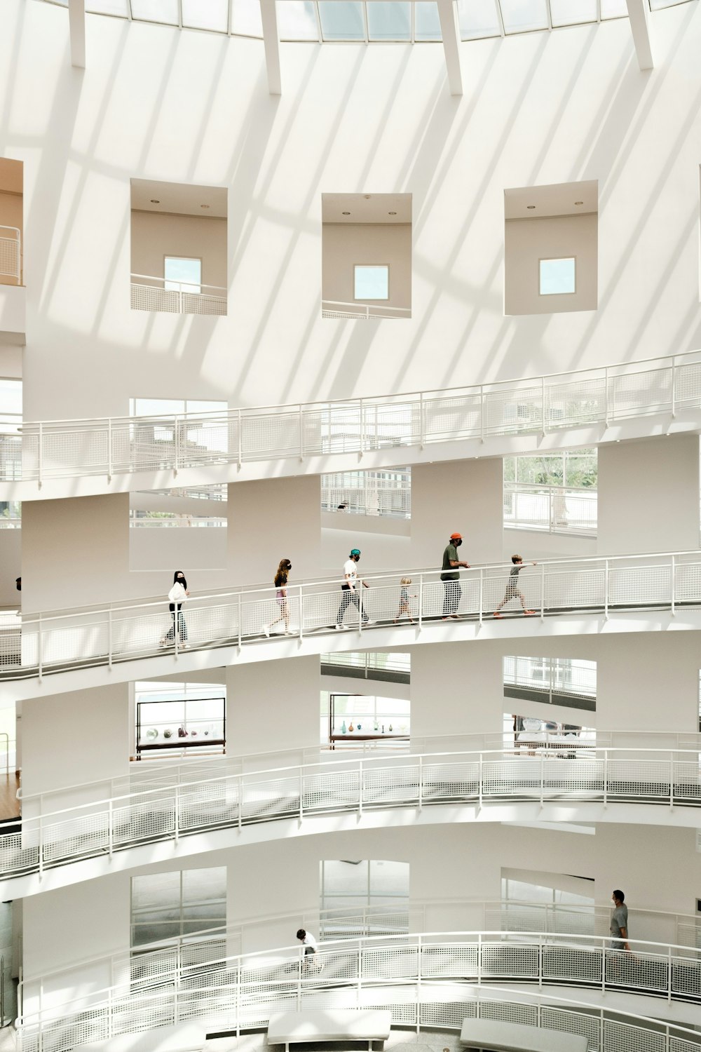 a group of people walking around inside of a building