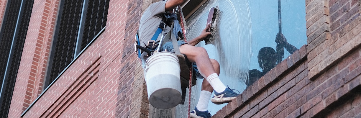 a man on a ladder working on a building