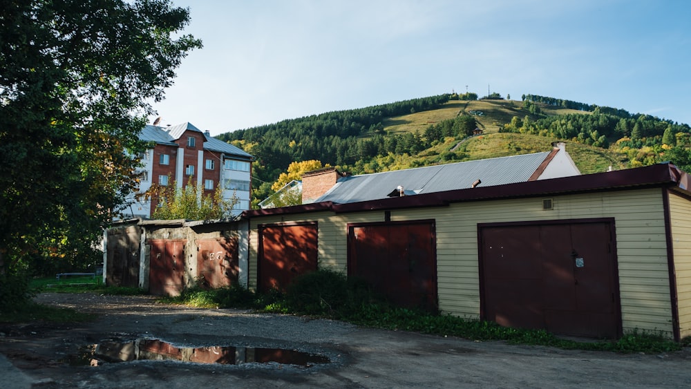 a building with a red roof and a mountain in the background