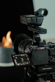 a video camera with a flame in the background