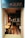 A cozy brasserie with an inviting interior characterized by warm lighting, wooden tables, and black chairs. The tiled floor features a geometric pattern in shades of brown and white. Mirrors and decorations adorn the walls, adding to the elegant and relaxed atmosphere.