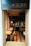 A cozy brasserie with an inviting interior characterized by warm lighting, wooden tables, and black chairs. The tiled floor features a geometric pattern in shades of brown and white. Mirrors and decorations adorn the walls, adding to the elegant and relaxed atmosphere.